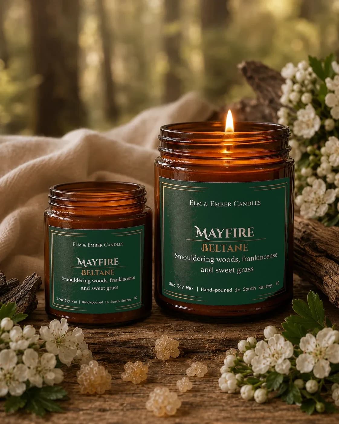 Mayfire candles with hawthorn blossom on linen