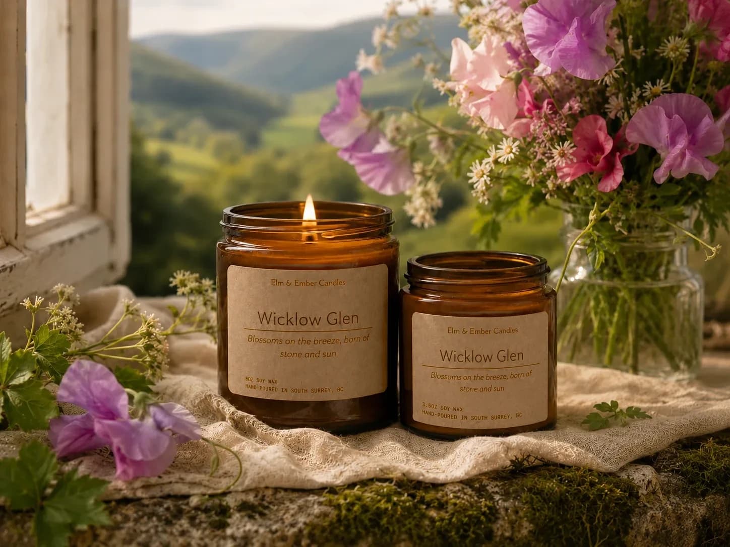 Wicklow Glen candles on a windowsill with sweet peas and green hills