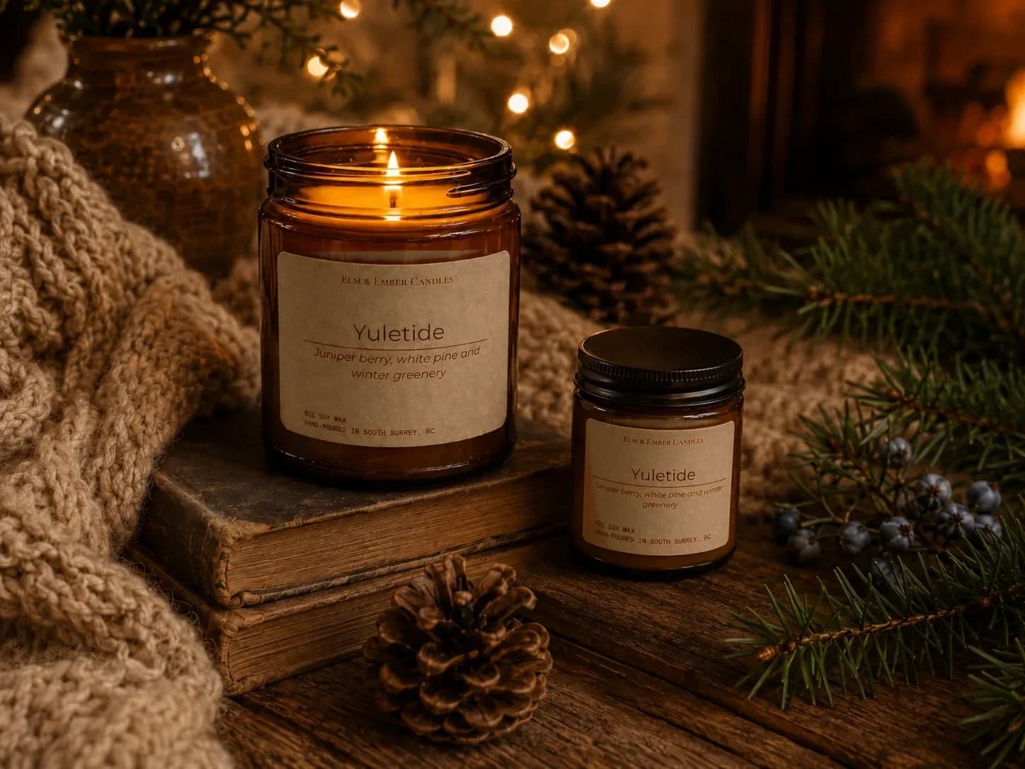 Yuletide candles on stacked books with pinecones and wool